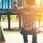 child swinging in park